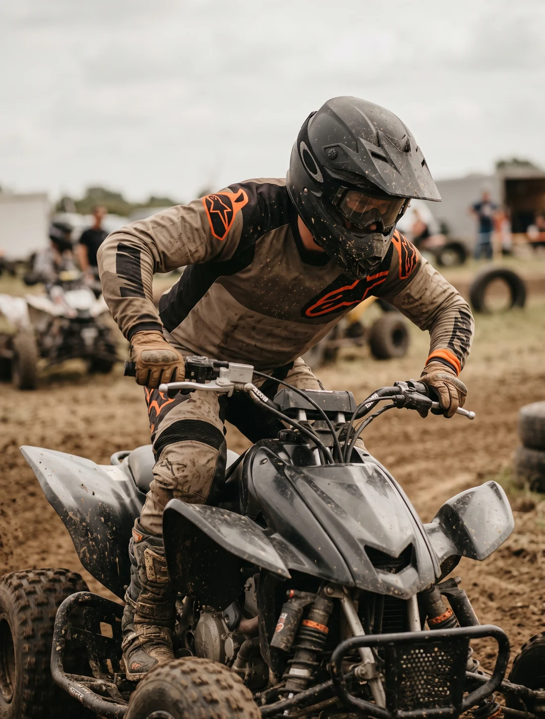 A quad rider at full lock, showing the load across the shoulders and upper arms